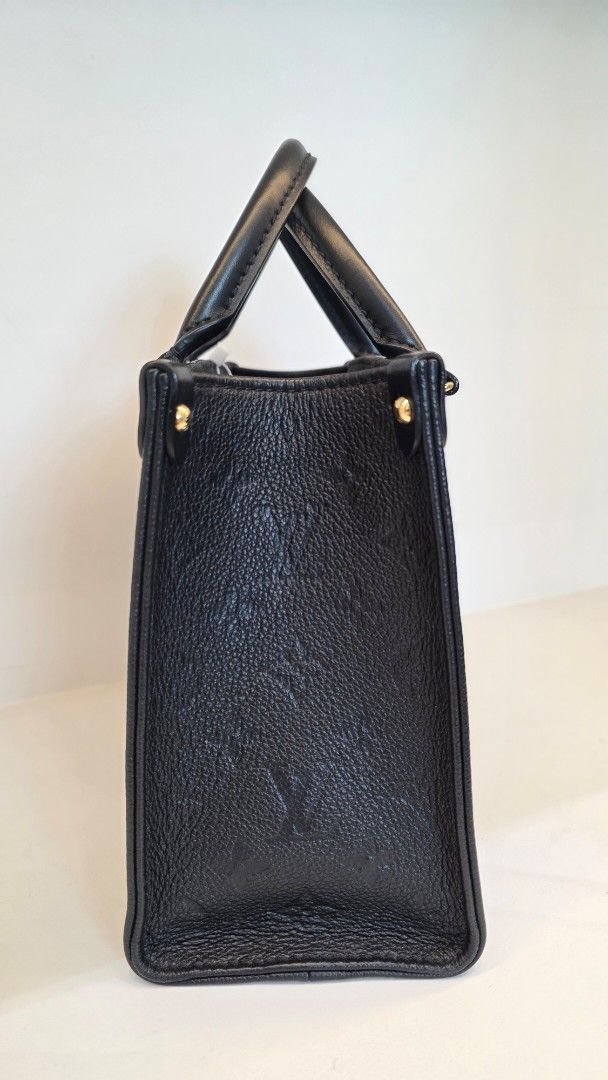 Louis Vuitton Empreinte OTG PM (Category: Luxury Bags & Wallets) located in San Fernando. Submitted by bagproject (Listing ID 1458620147, Image 2). Description: - Authentic Louis Vuitton Speedy Bag - Color: Black - Material: Monogram Empreinte Leather - Hardware: Gold-tone - Features: Top handles, detachable shoulder strap - Interior: Spacious, ideal for everyday essentials and more - Versatile: Suitable for daily use or special occasions - w/ En