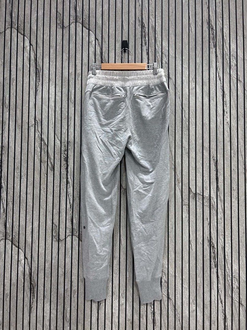 Lululemon Grey Joggers with Zipper Pockets (Category: Activewear) located in Malasiqui. Submitted by m3dus4 (Listing ID 1458628237, Image 3). Description: - Grey Lululemon joggers - Elastic waistband with drawstring - Two zippered front pockets - Small Lululemon logo on left leg - Ribbed ankle cuffs - Ideal for comfortable and stylish everyday wear Missing tag best fits small to medium .