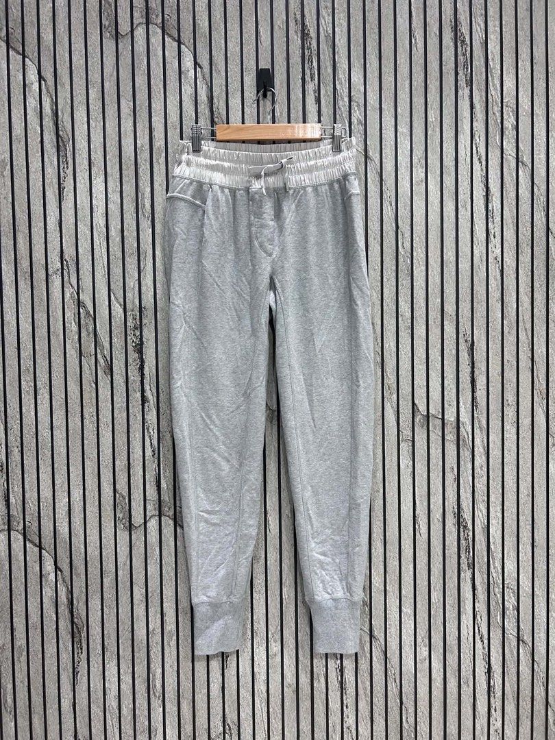 Lululemon Grey Joggers with Zipper Pockets (Category: Activewear) located in Malasiqui. Submitted by m3dus4 (Listing ID 1458628237, Image 2). Description: - Grey Lululemon joggers - Elastic waistband with drawstring - Two zippered front pockets - Small Lululemon logo on left leg - Ribbed ankle cuffs - Ideal for comfortable and stylish everyday wear Missing tag best fits small to medium .