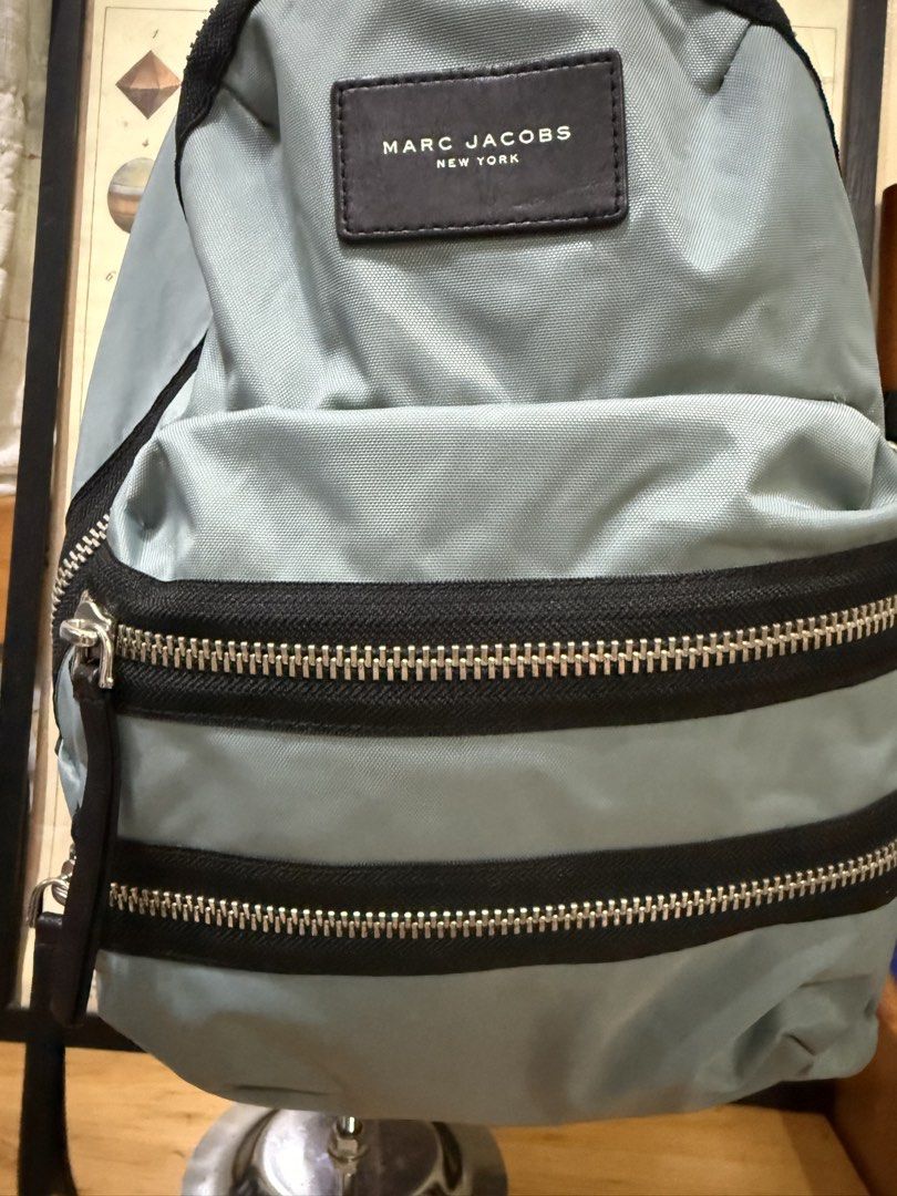 Marc Jacobs New York Light Blue Nylon Backpack (Category: Backpacks) located in Paranaque City. Submitted by christinashoppe (Listing ID 1458618781, Image 3). Description: - Light blue Marc Jacobs backpack - Made from durable nylon - Multiple zippered pockets on the front - Spacious main compartment with zipper closure - Adjustable shoulder straps for a comfortable fit - Ideal for everyday use and travel - Simple and functional design - stain und