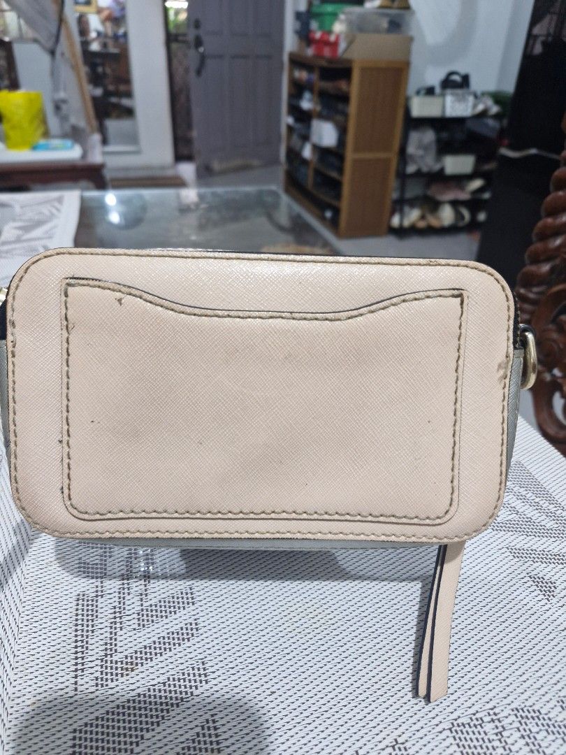 Marc Jacobs Snapshot Camera Bag - Beige/Silver (Category: Luxury Bags & Wallets) located in Las Pinas. Submitted by jmproperties (Listing ID 1458622332, Image 2). Description: - Authentic Marc Jacobs camera bag - Chic beige and silver colorway - Iconic gold double J logo hardware - Secure zipper closure - Adjustable strap for comfortable wear - Ideal for everyday essentials - Shows some signs of wear on hardware NO SLING STRAP included.