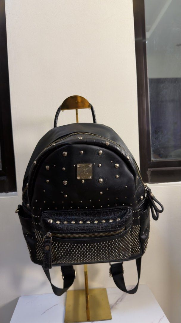MCM 2000s studded backpack (Category: Backpacks) located in Paranaque City. Submitted by preluxeshop_ph (Listing ID 1458684032, Image 2). Description: MCM 2000s studded backpack black top handle adjustable shoulder straps silver-tone studs front zip pocket main compartment zip closure Condition: GOOD. This previously owned and used item is in good condition with minimal signs of use. This may include fading of material or plating and scratches. P