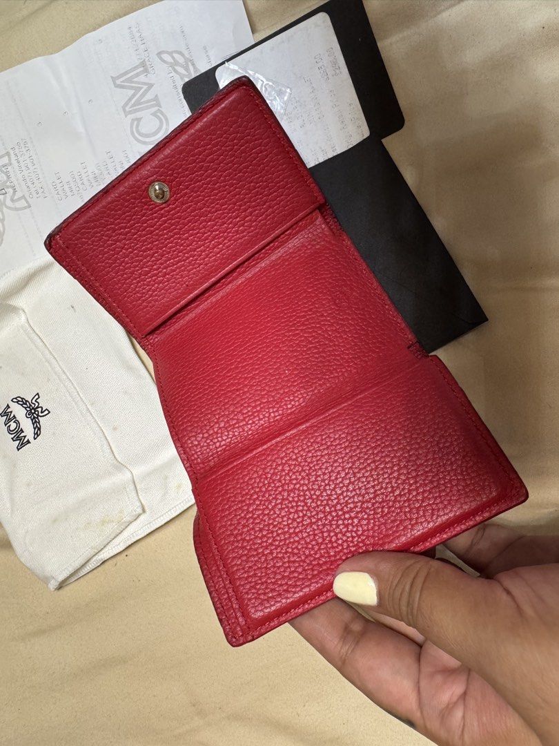 MCM Red Leather Trifold Wallet with Pouch and Box (Category: Luxury Bags & Wallets) located in Legazpi City. Submitted by grechaganda (Listing ID 1458593317, Image 3). Description: - Authentic red MCM trifold wallet - Made of textured leather - Comes with original dust bag, box, and receipt - Secure snap closure - Convenient small coin pocket - Ideal for keeping your essentials organized.