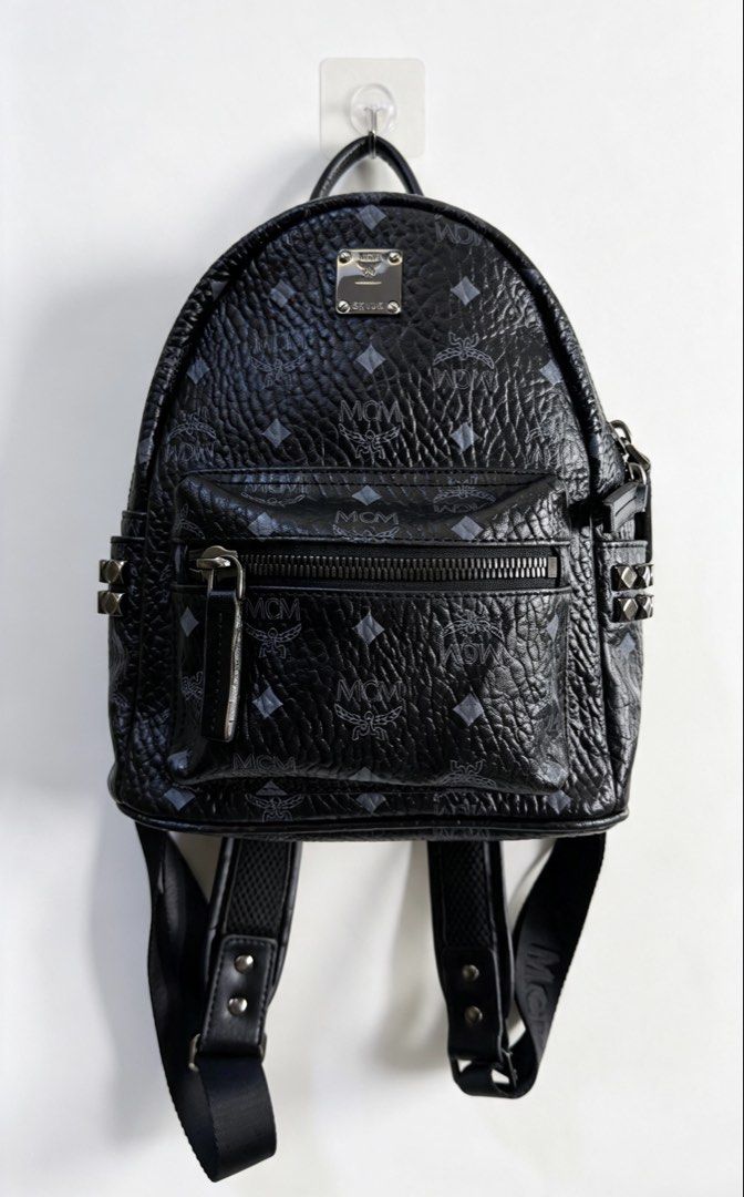 MCM Stark Backpack (Category: Backpacks) located in Paranaque City. Submitted by preluxeshop_ph (Listing ID 1458683971, Image 1). Description: MCM Stark Backpack black monogram print stud embellishment logo plaque adjustable shoulder straps single top handle front zip-fastening pocket two side slit pockets two-way zip fastening Made in Italy Product measurements Depth: 13 cm (5.11 in) Height: 33 cm (12.99 in) Width: 26 cm (10.23 in).