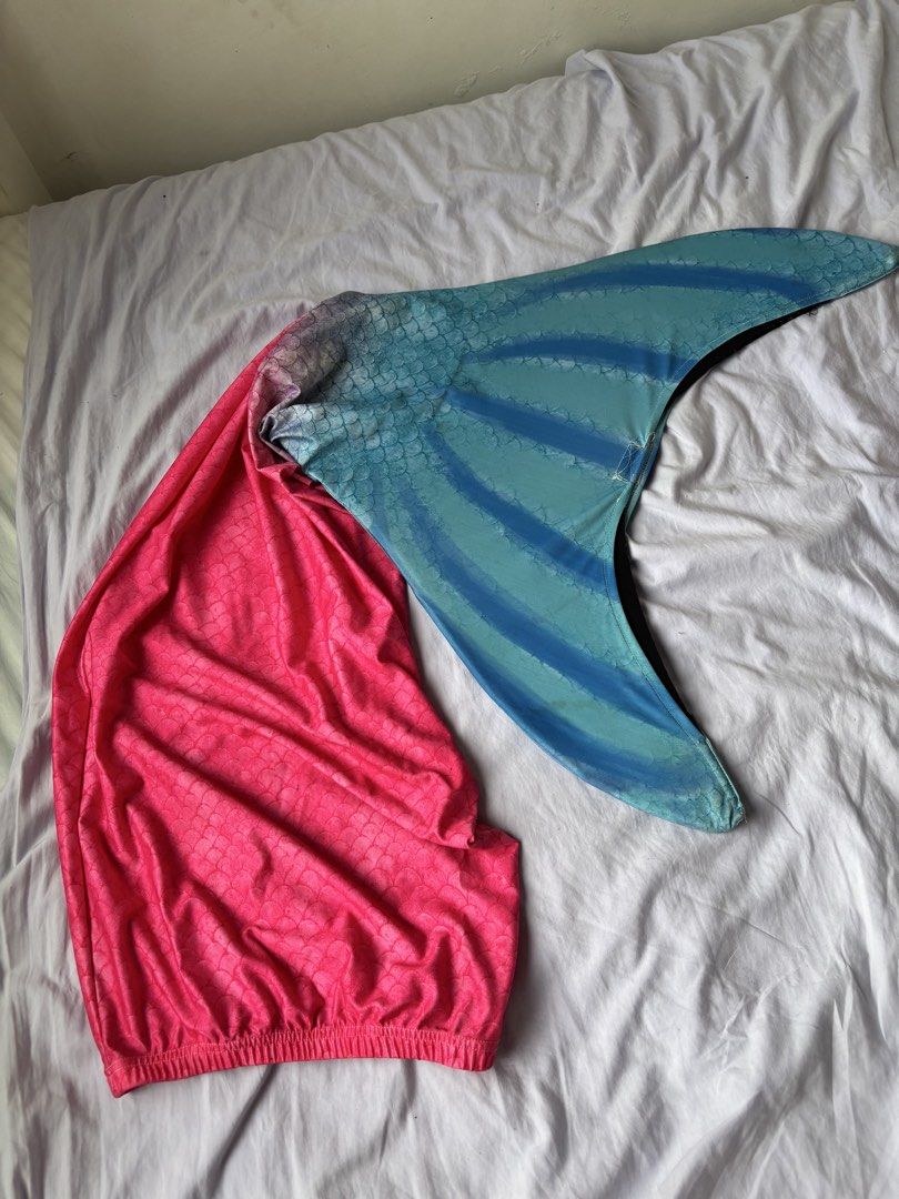 Mermaid Tail (Category: Babies & Kids Fashion) located in Paranaque City. Submitted by yanyannriley (Listing ID 1458566732, Image 2). Description: - Adorable mermaid tail costume - Features a beautiful pink and blue ombre color gradient - Detailed scale pattern for an authentic mermaid look - Made from comfortable, stretchy material - Ideal for playtime, dress-up, or beach fun.