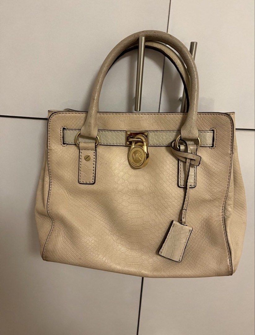 Michael Kors Beige Leather Satchel Handbag (Category: Luxury Bags & Wallets) located in Pasig City. Submitted by fmc828 (Listing ID 1458613288, Image 1). Description: - Authentic Michael Kors beige leather satchel - Signature MK lock closure for security - Multiple interior compartments for organization - Interior lining with classic MK logo pattern - Includes a small leather tag - Ideal for everyday wear and versatile styling.
