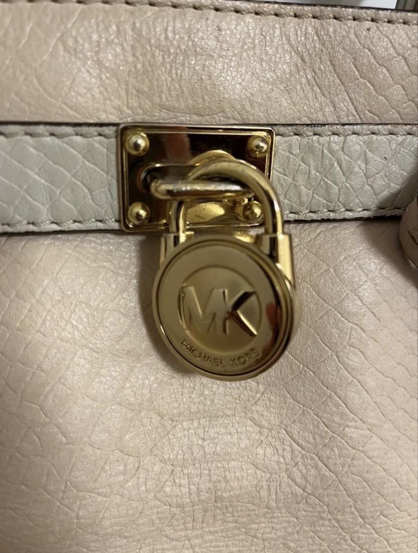 Michael Kors Beige Leather Satchel Handbag (Category: Luxury Bags & Wallets) located in Pasig City. Submitted by fmc828 (Listing ID 1458613288, Image 2). Description: - Authentic Michael Kors beige leather satchel - Signature MK lock closure for security - Multiple interior compartments for organization - Interior lining with classic MK logo pattern - Includes a small leather tag - Ideal for everyday wear and versatile styling.