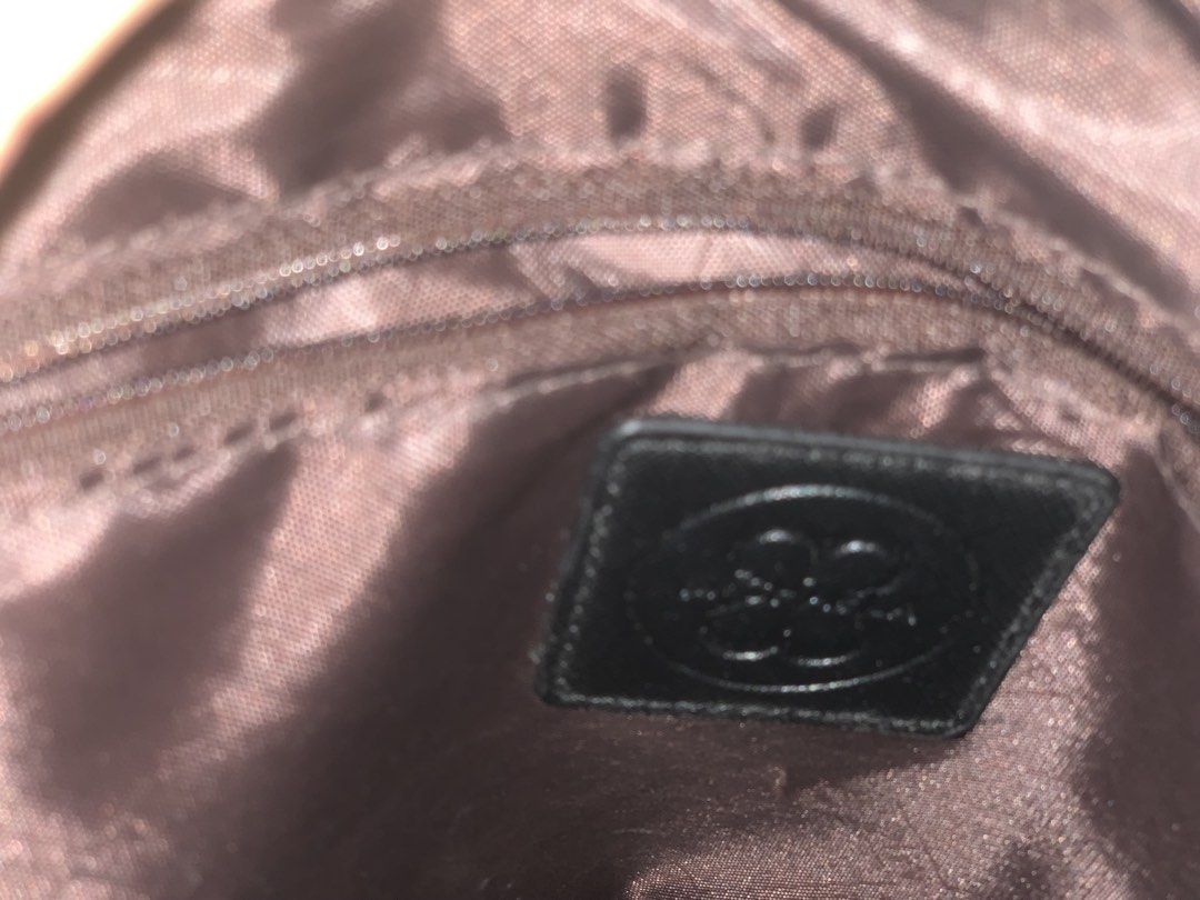 Michaela Black Tote Bag with Gold Hardware (Category: Tote Bags) located in Paranaque City. Submitted by rizatamayo (Listing ID 1458565513, Image 3). Description: - Classic black tote bag - Secure zip closure on top - Multiple interior compartments for organization - Convenient back zip pocket - Elegant gold hardware details - Includes a detachable shoulder strap.