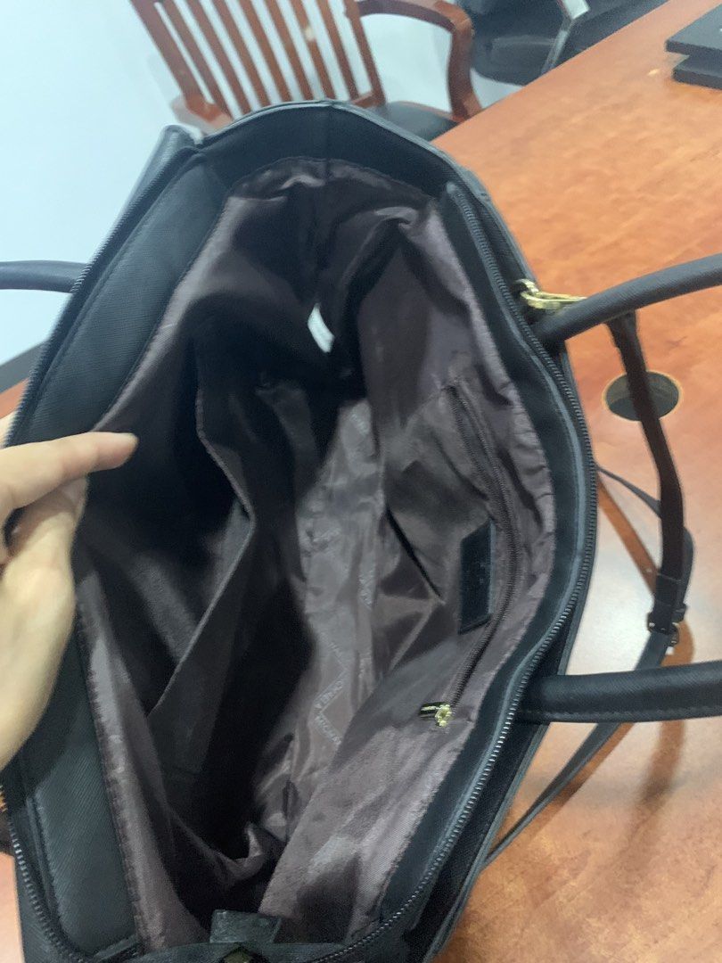 Michaela Black Tote Bag with Gold Hardware (Category: Tote Bags) located in Paranaque City. Submitted by rizatamayo (Listing ID 1458565513, Image 2). Description: - Classic black tote bag - Secure zip closure on top - Multiple interior compartments for organization - Convenient back zip pocket - Elegant gold hardware details - Includes a detachable shoulder strap.