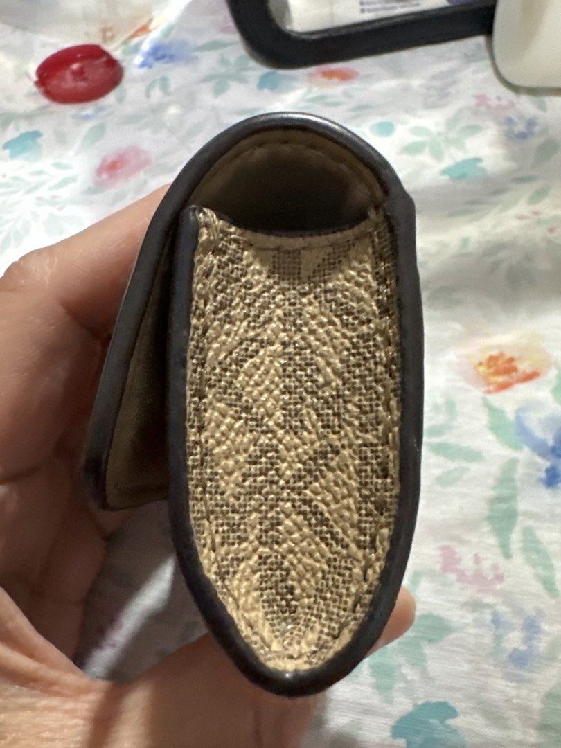 MK clip case (apple airpod) (Category: Headphones & Headsets) located in Pasay City. Submitted by docnanz67 (Listing ID 1458641742, Image 2). Description: This is a Michael Kors AirPods case featuring a beige leather flap with the signature gold-tone MK logo snap and monogram canvas.