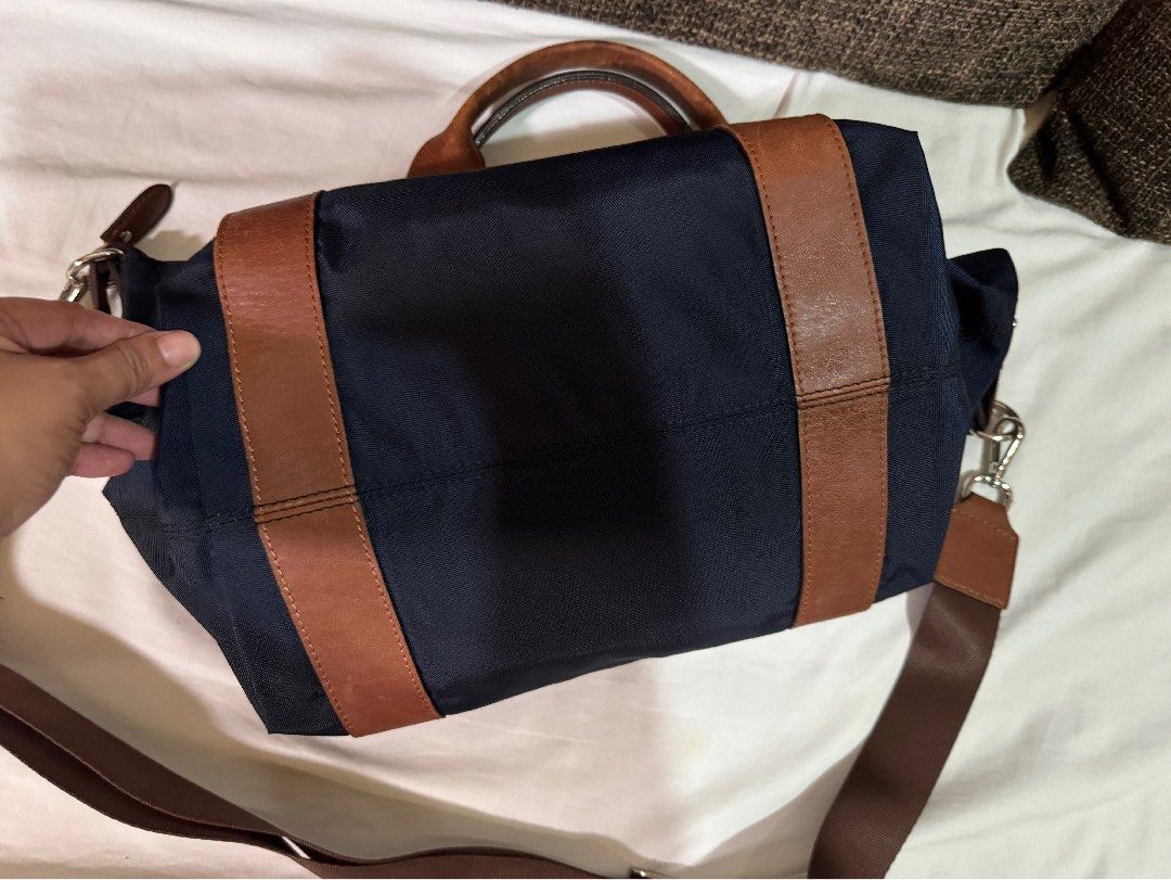 Navy Blue Fino Bag (Category: Shoulder Bags) located in Manila. Submitted by jhayzel09 (Listing ID 1458625960, Image 2). Description: - Navy blue bag with long strap - Features brown long straps and handles - Detachable shoulder strap included - Zips closed for secure storage - Perfect for office use and daily errands bought at fino store robinsons magnolia.