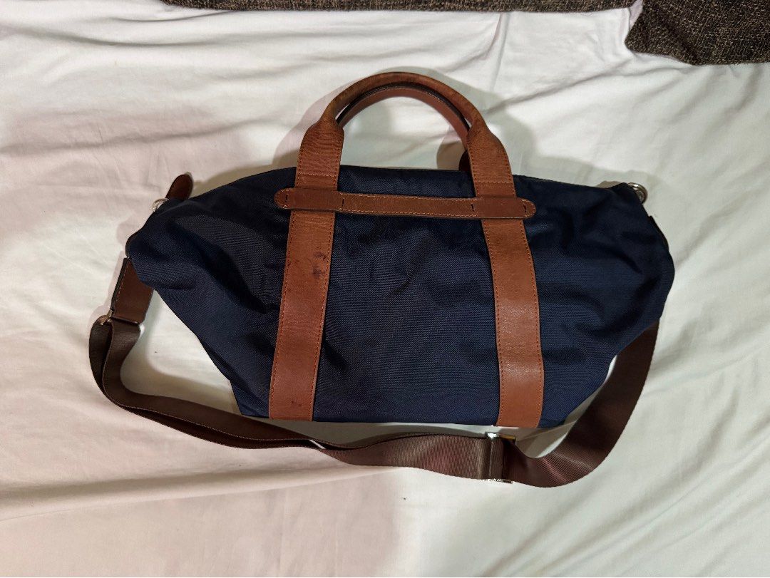 Navy Blue Fino Bag (Category: Shoulder Bags) located in Manila. Submitted by jhayzel09 (Listing ID 1458625960, Image 3). Description: - Navy blue bag with long strap - Features brown long straps and handles - Detachable shoulder strap included - Zips closed for secure storage - Perfect for office use and daily errands bought at fino store robinsons magnolia.