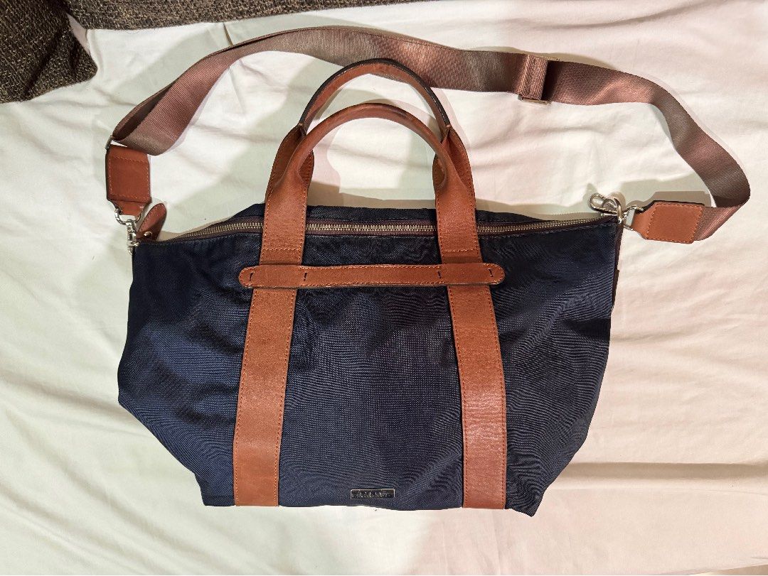 Navy Blue Fino Bag (Category: Shoulder Bags) located in Manila. Submitted by jhayzel09 (Listing ID 1458625960, Image 1). Description: - Navy blue bag with long strap - Features brown long straps and handles - Detachable shoulder strap included - Zips closed for secure storage - Perfect for office use and daily errands bought at fino store robinsons magnolia.