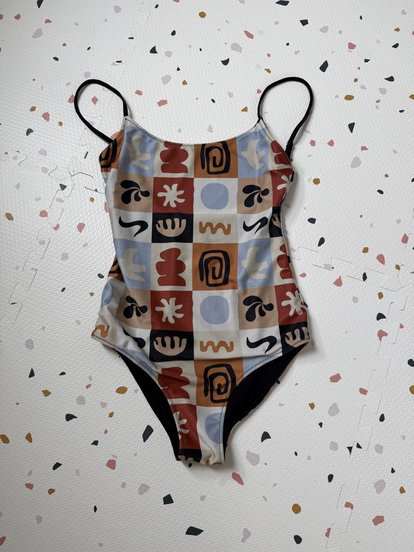 Nekid Swimwear Maillot (Category: Bikinis & Swimsuits) located in Pasig City. Submitted by diorisse (Listing ID 1458512265, Image 1). Description: - Adorable one-piece swimsuit - Unique abstract pattern with squares in brown, blue, white, and black - Features thin black straps - Lined with black fabric - Ideal for beach or pool outings.