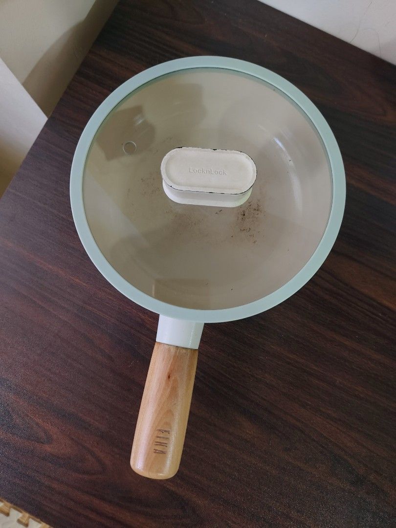 Neoflam 19cm Ceramic Pan with Lid (Category: Cookware & Accessories) located in Quezon City. Submitted by thelittlebookworm_ (Listing ID 1458687922, Image 2). Description: - White non-stick frying pan - Comfortable wooden handle with 'FIKA' branding - Includes a clear glass lid - Minor cosmetic marks inside the pan (does not affect performance) - Textured bottom surface for efficient heat distribution - Ideal for everyday cooking needs.