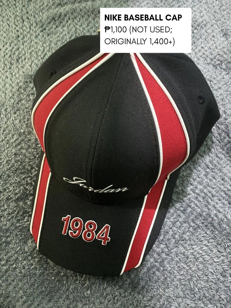 Nike Jordan 1984 Baseball Cap (Category: Caps & Hats) located in Manila. Submitted by dyerikobriyoool (Listing ID 1458641966, Image 1). Description: - Brand new Nike Jordan Baseball Cap - Color: Black with red and white trim - Features 'Jordan' embroidery on the front - '1984' detail on the brim - Never used, originally purchased for over ₱1,400.