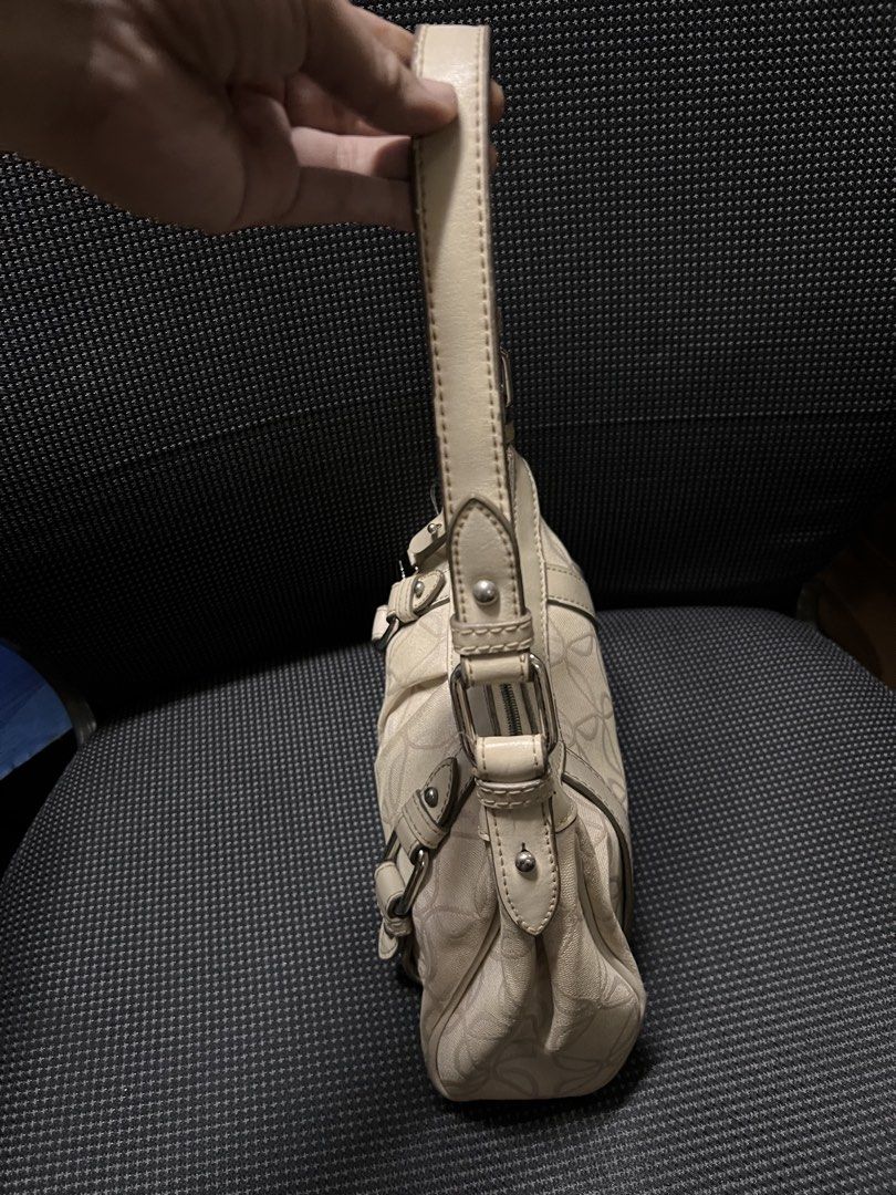 Nine West Cream Monogram Shoulder Bag (Category: Luxury Bags & Wallets) located in Quezon City. Submitted by rizza14ortiz (Listing ID 1458686126, Image 3). Description: - Classic cream Nine West shoulder bag - All-over Nine West monogram pattern - Stylish buckle details on the front - Secure zipper closure - Adjustable strap for comfortable wear - Interior zipper pocket - Clean and well-maintained interior.