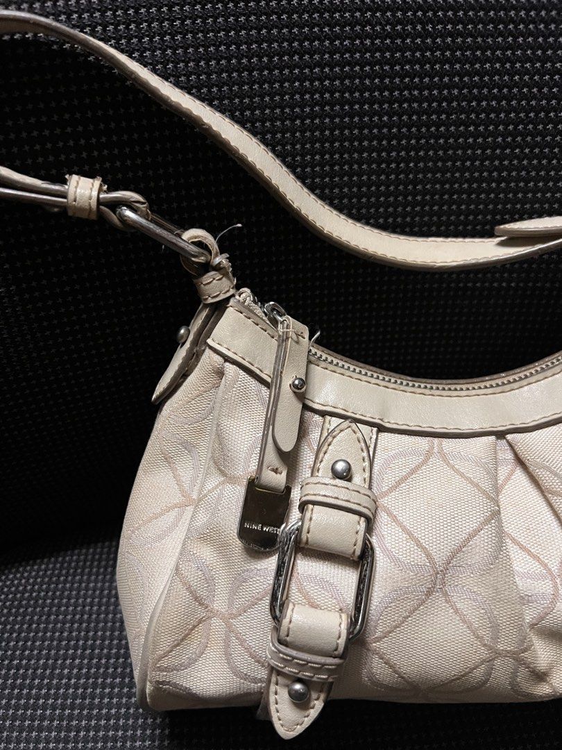 Nine West Cream Monogram Shoulder Bag (Category: Luxury Bags & Wallets) located in Quezon City. Submitted by rizza14ortiz (Listing ID 1458686126, Image 2). Description: - Classic cream Nine West shoulder bag - All-over Nine West monogram pattern - Stylish buckle details on the front - Secure zipper closure - Adjustable strap for comfortable wear - Interior zipper pocket - Clean and well-maintained interior.