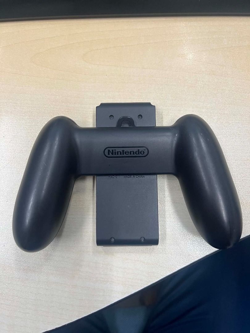 Nintendo Switch Joy-Con Charging Grip (Category: Controllers) located in Manila. Submitted by cdcalarcon82801 (Listing ID 1458524039, Image 2). Description: - Original Nintendo Switch Charging Grip - Play with Joy-Cons attached - Charges Joy-Cons while you play - Ideal for longer gaming sessions - Provides a better grip for enhanced gameplay - Compatible with Nintendo Switch.