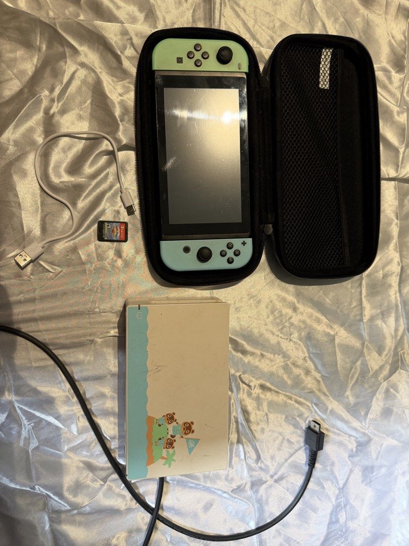 Nintendo Switch V1 (Category: Nintendo) located in Makati City. Submitted by sleekchic.jms (Listing ID 1458651380, Image 2). Description: 🎮 FOR SALE | Nintendo Switch V1 💚 Complete bundle: ✨ Switch V1 console + Joy-Cons ✨ Animal Crossing design dock ✨ Mario Kart 8 Deluxe game card ✨ Hard case ✨ HDMI cable ✨ Charger — non-original 💰 ₱9500 slightly negotiable 📌 Unit is working and in good condition. 📌 Charger included is not the original Ninte