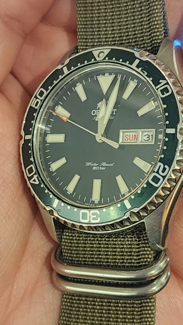 Orient Automatic Diver Watch Green Bezel (Category: Men's Watches) located in Manila. Submitted by onceuu (Listing ID 1458664955, Image 2). Description: - Orient Kamasu Watch - Green bezel - Greeb dial with luminous hands and markers - Day and date complication at 3 o'clock - Water resistant 20 bar (200 meters) - Includes a green NATO strap - Watch is running well -First Owner Slighty Negotiable .