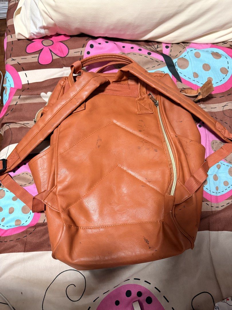 ORIGINAL Anello Brown Faux Leather Backpack (Category: Backpacks) located in Paranaque City. Submitted by keyas.preloved (Listing ID 1458579856, Image 2). Description: - Brown faux leather backpack - Main compartment with internal pockets - Front zippered pocket - Two side pockets - Adjustable straps - Exterior shows some scuffs and marks, particularly on the back but you can wash it for it to be removed - Interior is clean.