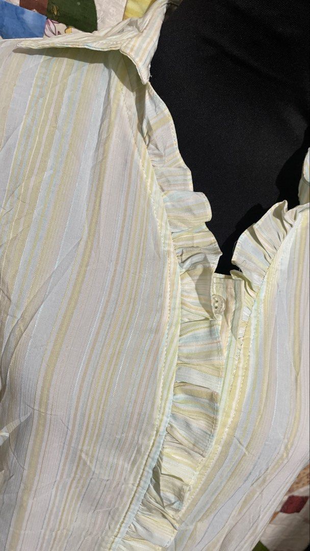 Pastel Vertical Stripe Ruffle Trim Button-Down Blouse (Size L) (Category: Blouses) located in Roxas City. Submitted by budgetfindsroxasph (Listing ID 1458574646, Image 3). Description: Add a sweet, vintage touch to your collection with this lightweight pastel striped short-sleeve blouse. Features soft yellow, light blue and neutral vertical stripes, an open-notch collar, dainty ruffle-trimmed sleeves, and a delicate ruffled front placket over hid