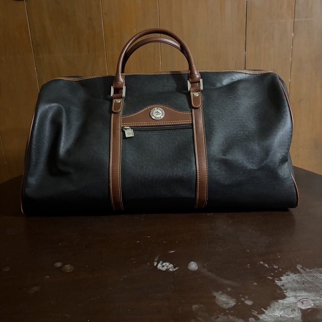 Pierre Balmain Paris Black Leather Duffle Bag (Category: Luxury Bags & Wallets) located in Quezon City. Submitted by slightlymawts (Listing ID 1458549924, Image 2). Description: - Classic black duffle bag by Pierre Balmain - Features brown leather trim and handles - Zippered front pocket - Main zippered compartment - Ideal for weekend trips or carry-on luggage - Vintage quality - Rarely used RFS: decluttering .