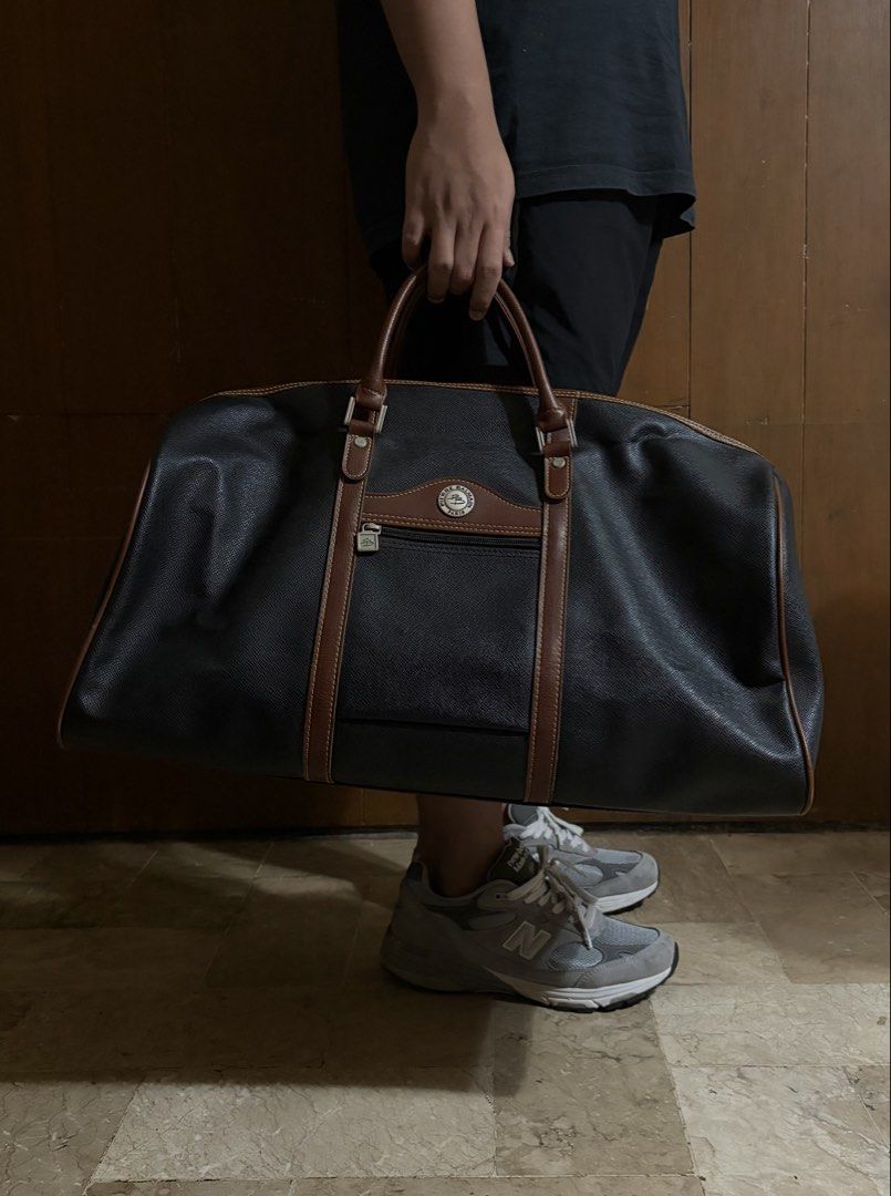 Pierre Balmain Paris Black Leather Duffle Bag (Category: Luxury Bags & Wallets) located in Quezon City. Submitted by slightlymawts (Listing ID 1458549924, Image 1). Description: - Classic black duffle bag by Pierre Balmain - Features brown leather trim and handles - Zippered front pocket - Main zippered compartment - Ideal for weekend trips or carry-on luggage - Vintage quality - Rarely used RFS: decluttering .