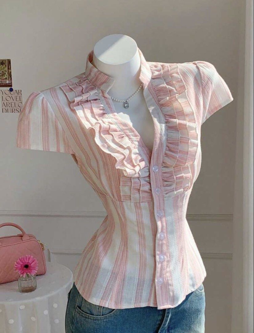 Pink and White Striped Ruffle Button-Up Blouse (Category: Blouses) located in Quezon City. Submitted by luna_ily (Listing ID 1458614794, Image 3). Description: 🍒 Retail price is ₱500. 🍒 Condition: Brand new. Only fit once. 🍒 Comes with a tie to cinch the waist. 🍒 Don’t hesitate to send a message for further details and inquiries. Location: Cubao, Quezon City Mode of delivery: J&T and Lalamove (shipping fee will be shouldered by the buyer) Mod