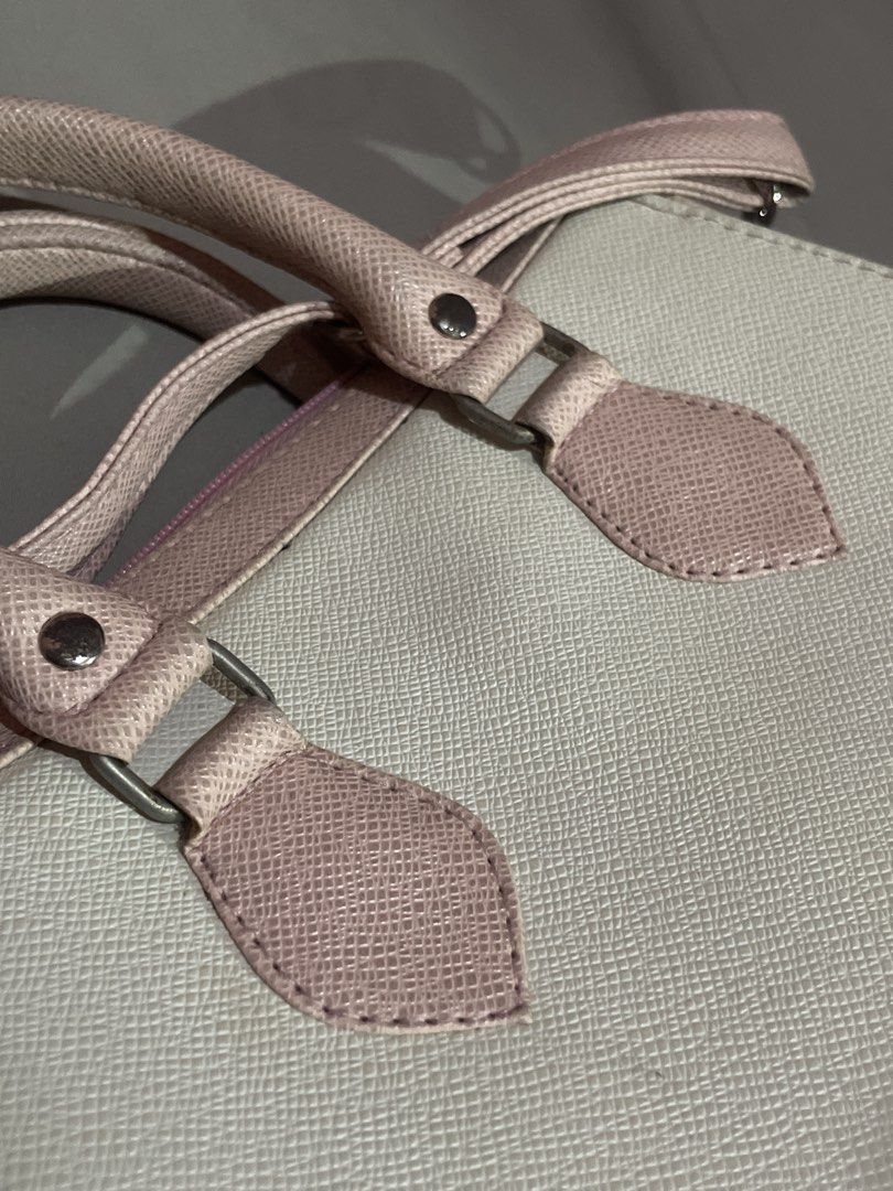 Pink and White Structured Handbag with Shoulder Strap (Category: Shoulder Bags) located in Taguig. Submitted by prelovedttuh (Listing ID 1458648620, Image 3). Description: - Cute pink and white handbag - Structured design with top handles - Includes a detachable shoulder strap - Features a lovely textured material - Spacious interior for all your essentials - Versatile for everyday use or evening outings.