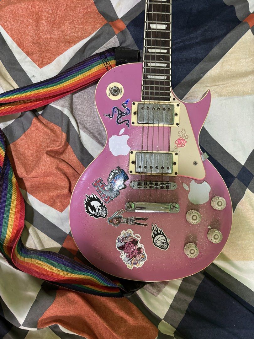 Pink Electric Guitar with Rainbow Strap (rush) (Category: Musical Instruments) located in General Mariano Alvarez. Submitted by havenzxc (Listing ID 1458538740, Image 1). Description: PINK ELECTRIC GUITAR (rush) W STRAP CAN DO MEETUPS AROUND DASMA CAN DO SHIPPING ( BUYER WILL BOOK OWN RIDER) RFS- Di na nagagamit nakatambak na lang Honest issue - Minor scratches -old strings (need new) -need cleaning Other than that po plug and play na.