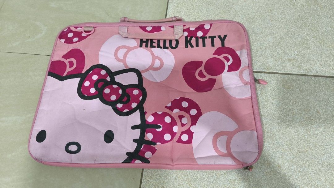 Pink Hello Kitty Laptop Sleeve Bag (Category: Laptop Bags & Sleeves) located in Caloocan City. Submitted by majehjembo8 (Listing ID 1458627247, Image 1). Description: - Cute pink Kitty laptop sleeve - Features iconic Kitty face and all-over bow print - Includes a top handle for easy carrying - Zipper closure for secure storage - Stylish protection for your laptop - Shows some signs of wear, but fully functional.