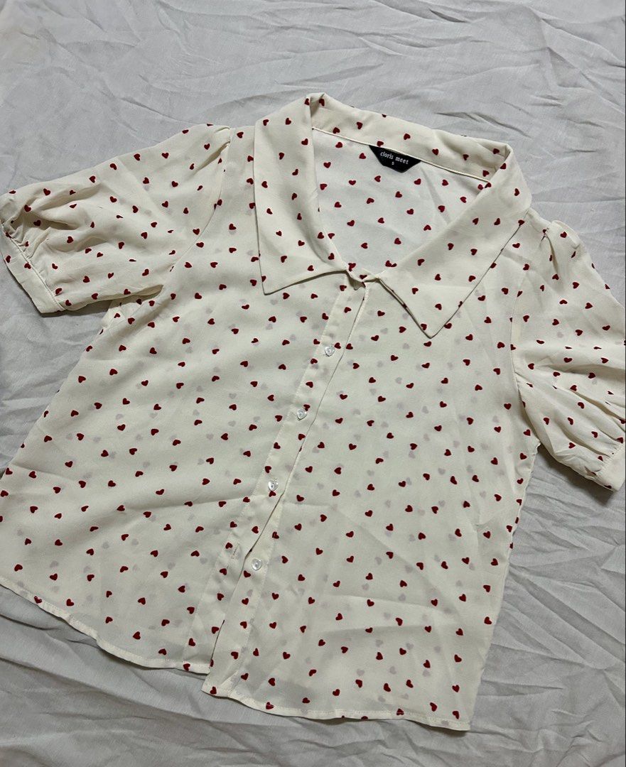 Polka-Heart Blouse (Category: Blouses) located in Quezon City. Submitted by rarefaithyyy (Listing ID 1458670292, Image 1). Description: *short-sleeve button-up blouse features a playful red heart print * thrifted expect minimal issues * size s ‼️ reminders before purchasing ‼️ - no cancellation/return/refund of orders - mop: cash/gcash/banking - mod: meet-up/j&t/lalamove - meet up or shipping every Tuesdays and Thursdays only - meet up place: Cub