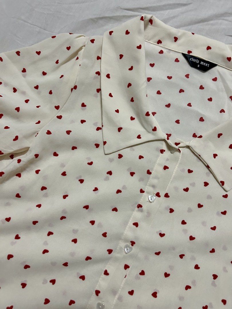 Polka-Heart Blouse (Category: Blouses) located in Quezon City. Submitted by rarefaithyyy (Listing ID 1458670292, Image 3). Description: *short-sleeve button-up blouse features a playful red heart print * thrifted expect minimal issues * size s ‼️ reminders before purchasing ‼️ - no cancellation/return/refund of orders - mop: cash/gcash/banking - mod: meet-up/j&t/lalamove - meet up or shipping every Tuesdays and Thursdays only - meet up place: Cub