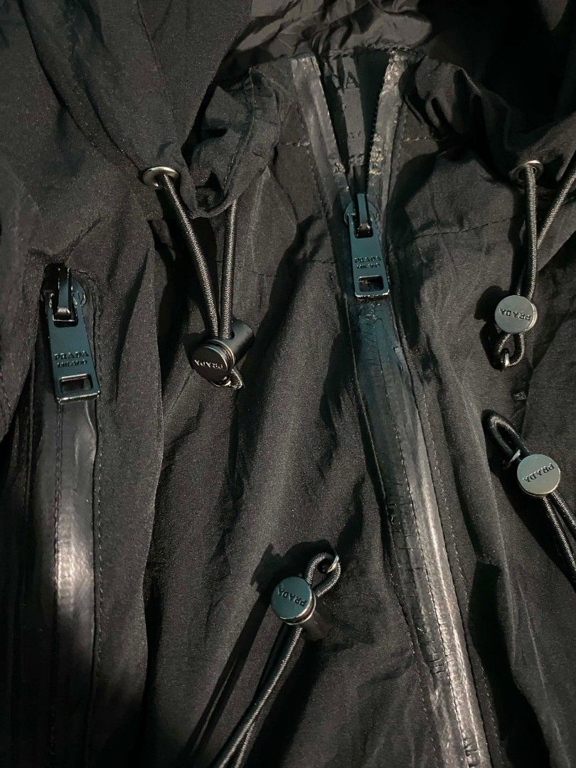 Prada Milano Black Hooded Jacket Size 50 (Category: Coats, Jackets and Outerwear) located in Manila. Submitted by jiyeee22 (Listing ID 1458664976, Image 2). Description: - Authentic black Prada hooded jacket - Size 50 - Zip closure - Iconic Prada Milano logo patch on chest - Adjustable drawstrings at hood and hem - Made in Mauritius - Please check photos for detailed condition.