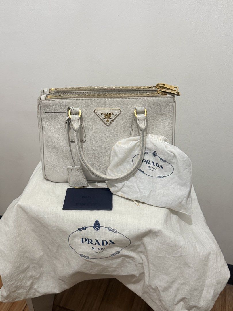 Prada Saffiano Lux Tote Bag (Category: Luxury Bags & Wallets) located in Manila. Submitted by scents_and_scentsibility (Listing ID 1458520589, Image 1). Description: - Authentic Prada Saffiano Lux Tote Bag - Color: white - Includes: Dust Bag, Authenticity Card - Hardware: Gold - Features: Smoothly working zippers - Style: Classic, versatile, perfect for everyday use Size is small, rare for this style Negotiable .
