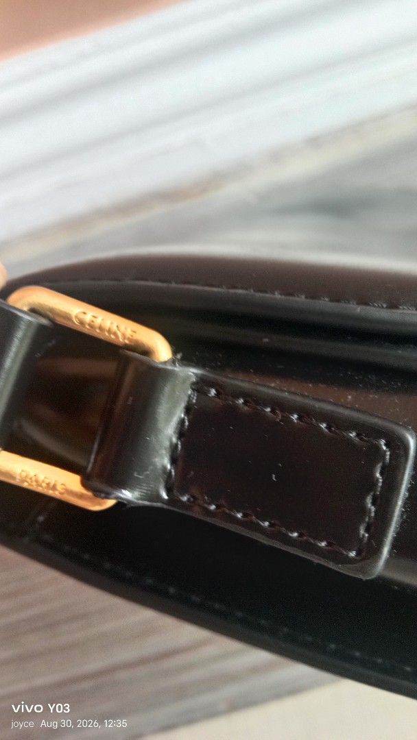 Preloved Celine Triomphe Shoulder Bag Black Leather (Category: Luxury Bags & Wallets) located in Cabuyao City. Submitted by selections888 (Listing ID 1458538369, Image 3). Description: - preloved Celine shoulder bag in black leather. - Features iconic gold-tone Triomphe clasp. - Adjustable shoulder strap for comfort. - Interior displays a subtle Celine Paris logo. - Leather shows minor signs of wear (scuffs), consistent with normal use. - Interio