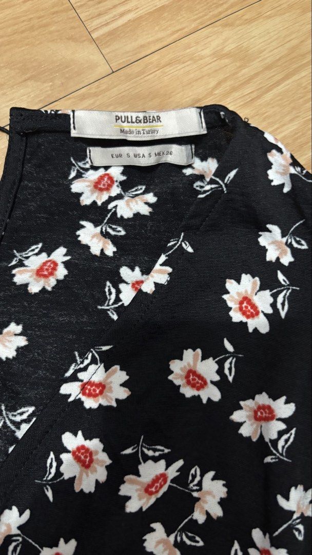Pull & Bear Black Floral Wrap Mini Dress Size S (Category: Dresses) located in Cainta. Submitted by prelovebytish (Listing ID 1458526249, Image 2). Description: - Cute black mini dress - White and red floral print - Short sleeves - Flattering wrap style - Lightweight and flowy fabric - Perfect for casual outings or a day out - Made in Turkey - Size S.