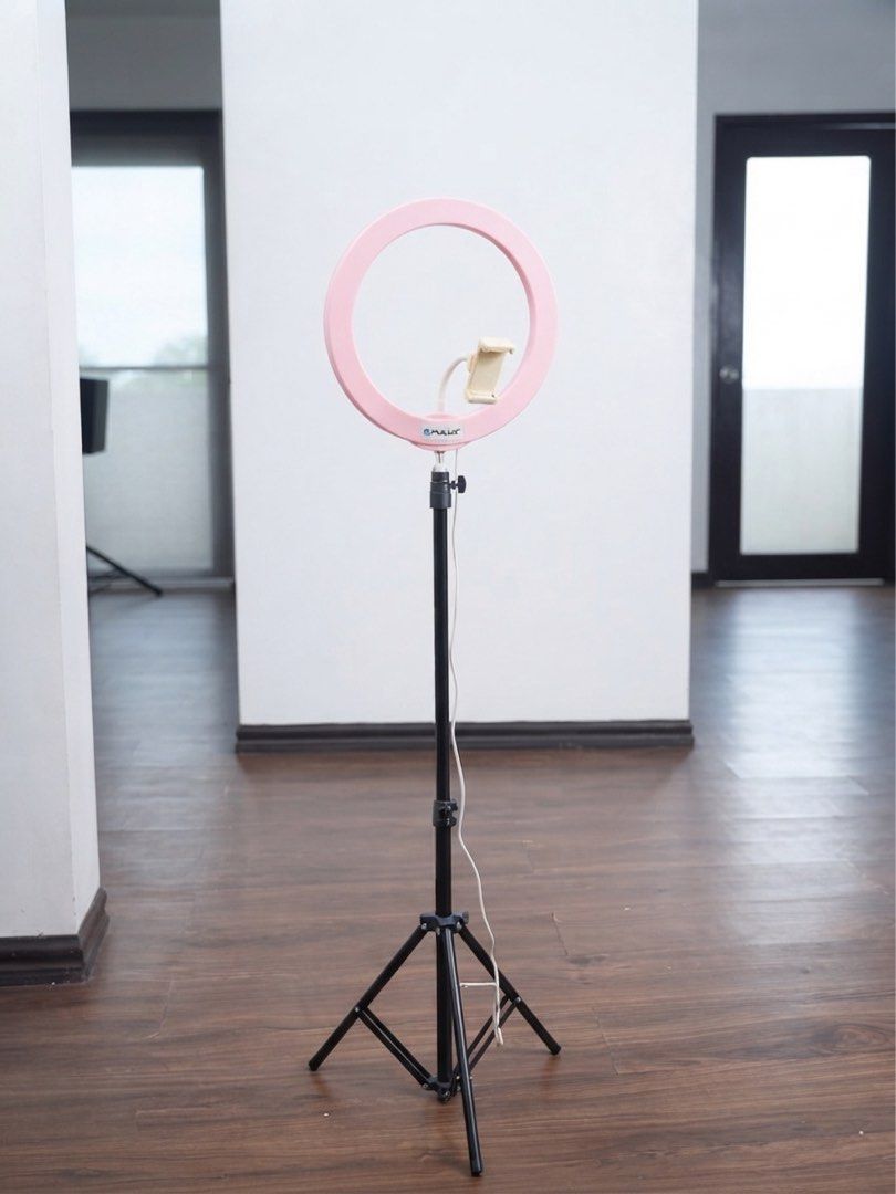 Puluz LED Ring Light with Adjustable Tripod Stand (Category: Lighting & Studio Equipment) located in Taguig. Submitted by jcbpeter (Listing ID 1458626273, Image 1). Description: vibrant pink ring light frame with an integrated flexible smartphone mount, mounted on a sturdy, height-adjustable tripod stand. Condition: Excellent / Gently Used Brand: Puluz Inclusions: Ring light with phone holder, adjustable tripod stand, and power cable with inline 