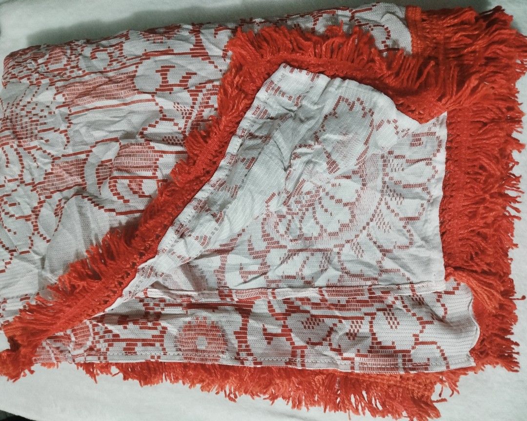 Red Ornage and White Patterned Tablecloth with Fringe (Category: Table Linen & Textiles) located in Imus. Submitted by stop_shop7 (Listing ID 1458572336, Image 3). Description: - Eye-catching red and white geometric and floral pattern. - Elegant fringe trim along all edges. - Textured weave fabric for a premium feel. - Perfect for livening up your dining table or as a decorative accent. - Versatile use as a tablecloth or throw. -size 68*98in..