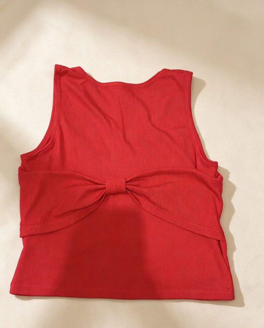 Red Ribbed Tank Top with Bow Detail (Category: Sleeveless) located in Manila. Submitted by mighty.keii_ (Listing ID 1458654486, Image 1). Description: - Cute red ribbed tank top - Features a sweet bow detail in the front - Sleeveless design - Versatile for casual wear or dressing up - Pairs easily with jeans or skirts - Comfortable and stylish.