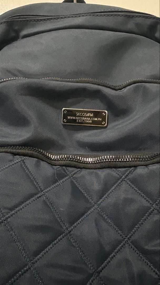 Secosana Navy Blue Quilted Front Nylon Backpack (Category: Backpacks) located in Manila. Submitted by clove127 (Listing ID 1458688886, Image 2). Description: - Price Negotiable! - Size Kasya Tablet/Ipad/ A5 Binder/ Tumbler / Payong - Condi is Like New/ lightly used - Zippers are all working - No stain/tear/scratch - adjustable straps - multiple pockets so oraganized and spacious inside with more zippers and compartment .