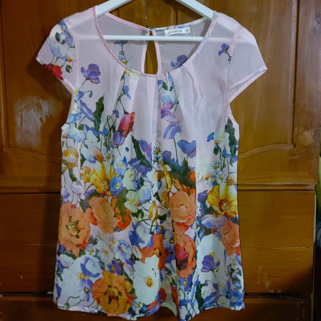 Sheer Floral Print Cap Sleeve Blouse (Category: Blouses) located in Manila. Submitted by toloveandtofold (Listing ID 1458546605, Image 1). Description: - Light pink sheer blouse - Vibrant floral print - Cap sleeves - Keyhole back closure - Lightweight and airy fabric - Versatile for casual or dressed-up looks - Easy to pair with jeans or skirts.