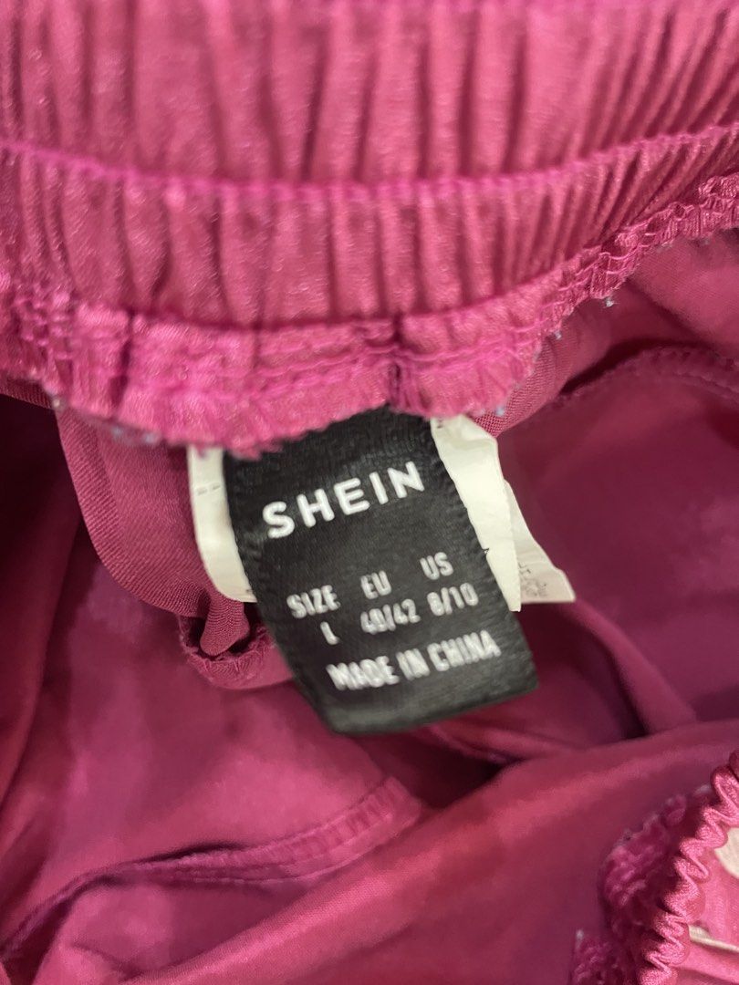 SHEIN Pink Satin Track Pants (Category: Other Bottoms) located in Quezon City. Submitted by TGDL123 (Listing ID 1458567105, Image 2). Description: - SHEIN pink satin track pants - Elastic waistband with drawstring - White stripe detail down the sides - Wide leg fit - Ideal for casual wear or lounging -15x37”. layflat.