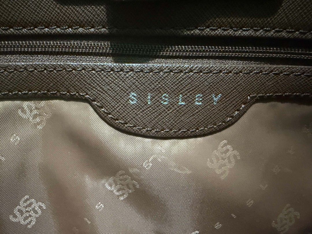 Sisley Brown Textured Tote Bag (Category: Tote Bags) located in Manila. Submitted by niklaus_12345 (Listing ID 1458557574, Image 3). Description: - Brown textured tote bag by Sisley - Elegant gold hardware details - Secure zipper closure - Interior lined with Sisley logo - Spacious and ideal for everyday use.