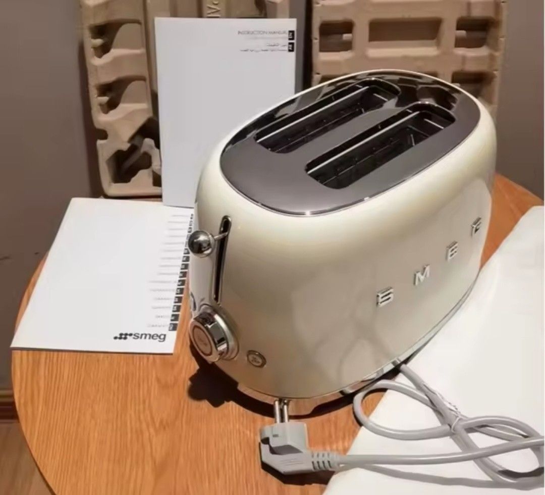 SMEG 2-Slice Toaster (TSF01) (Category: Ovens & Toasters) located in Manila. Submitted by thebageditph (Listing ID 1458686862, Image 1). Description: SMEG 2-Slice Toaster (TSF01) cream Smeg 2-slice toaster featuring a glossy retro 1950s design.