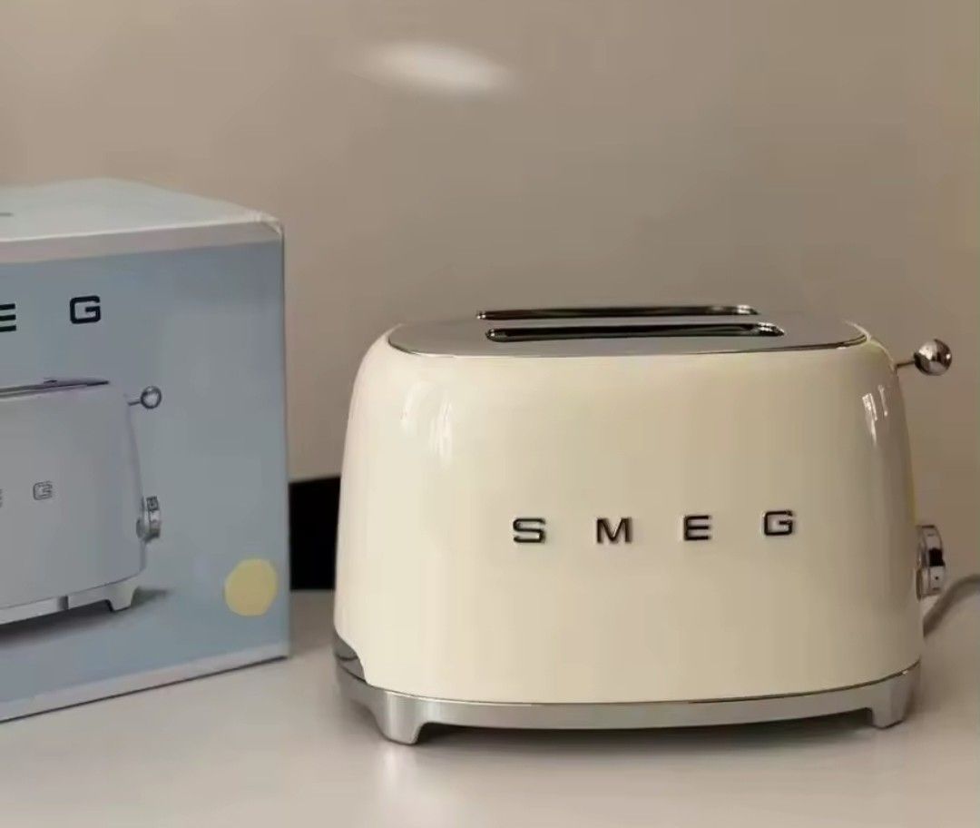 SMEG 2-Slice Toaster (TSF01) (Category: Ovens & Toasters) located in Manila. Submitted by thebageditph (Listing ID 1458686862, Image 2). Description: SMEG 2-Slice Toaster (TSF01) cream Smeg 2-slice toaster featuring a glossy retro 1950s design.