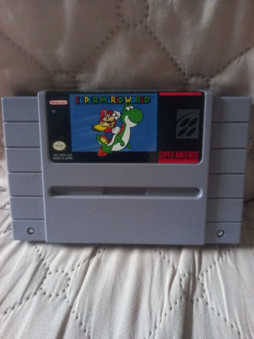 Super Mario World SNES Game Cartridge (Category: Nintendo) located in Valenzuela. Submitted by retro.rush (Listing ID 1458572242, Image 1). Description: - Classic Super Mario World for Super Nintendo (SNES) - Play as Mario and ride Yoshi! - Tested and confirmed working - Essential addition for any retro gaming collection.