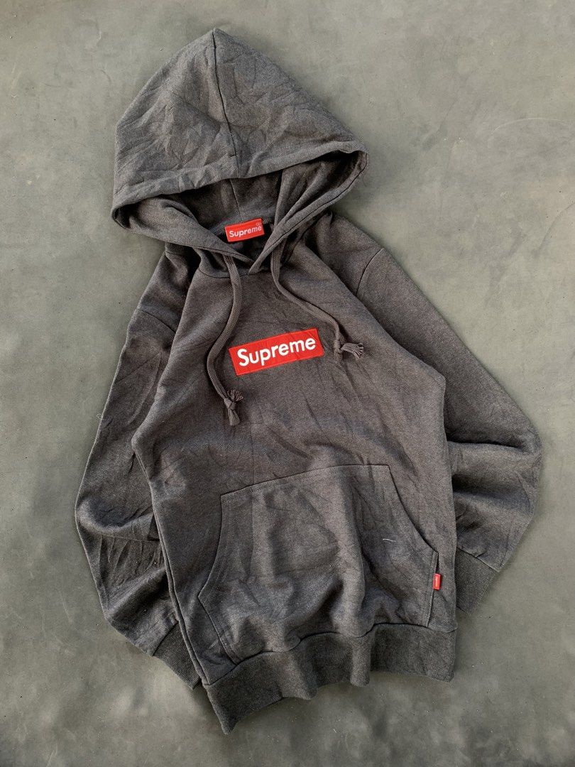 Supreme Grey Box Logo Hoodie (Category: Hoodies) located in Valencia. Submitted by davehandpicked (Listing ID 1458651469, Image 1). Description: - Classic Supreme hoodie - Grey colorway with iconic red box logo - Hood and drawstrings intact - Front pocket present - Great for everyday wear - Please check photos for detailed condition.